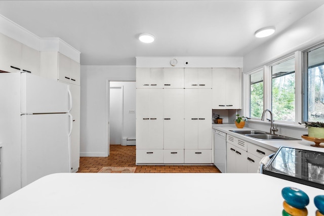 1657 Glenwood Rd, Ann Arbor, MI 48104 - kitchen featuring white appliances, a sink, a baseboard radiator, brick patterned flooring, and light countertops