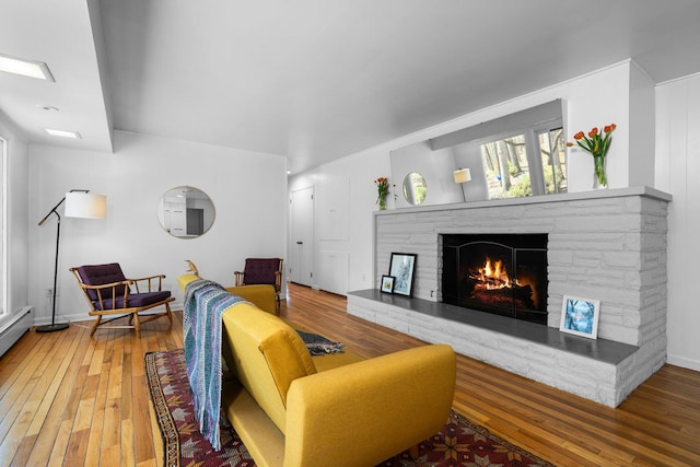 1657 Glenwood Rd, Ann Arbor, MI 48104 - living area featuring a stone fireplace, hardwood / wood-style flooring, and baseboards
