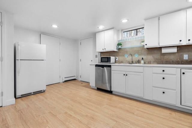 1657 Glenwood Rd, Ann Arbor, MI 48104 - kitchen with white appliances, a baseboard heating unit, a sink, light wood-type flooring, and white cabinetry