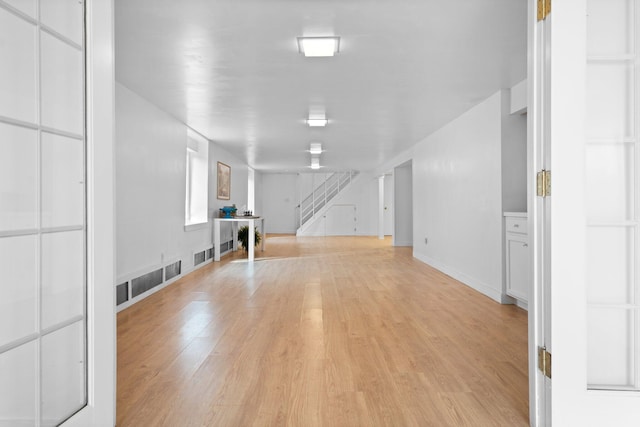 1657 Glenwood Rd, Ann Arbor, MI 48104 - spare room featuring light wood-style floors, stairway, and baseboards