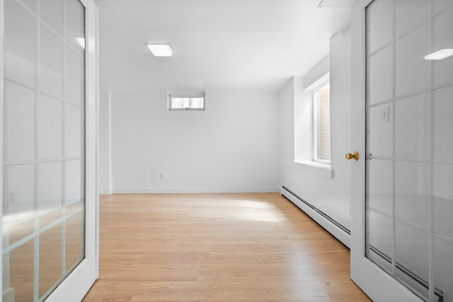 1657 Glenwood Rd, Ann Arbor, MI 48104 - spare room with a baseboard heating unit, light wood-style flooring, and healthy amount of natural light