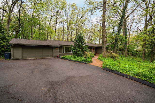 1657 Glenwood Rd, Ann Arbor, MI 48104 - ranch-style house with an attached garage and asphalt driveway