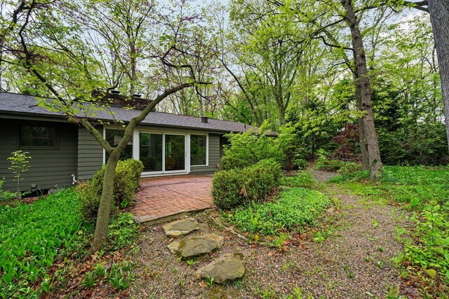 1657 Glenwood Rd, Ann Arbor, MI 48104 - rear view of house featuring a patio and roof with shingles
