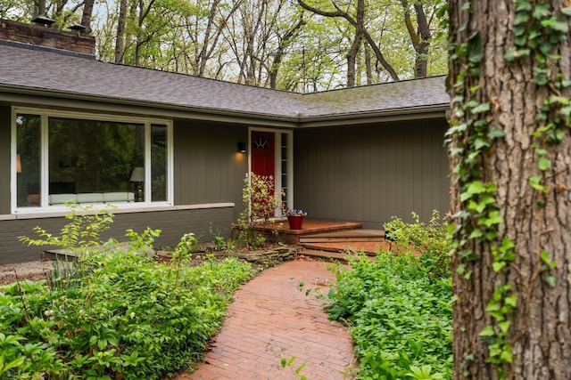 1657 Glenwood Rd, Ann Arbor, MI 48104 - doorway to property featuring a chimney and brick siding