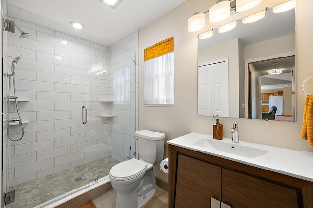 bathroom with a stall shower, vanity, connected bathroom, and toilet