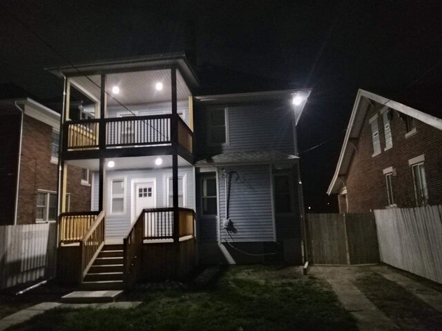 4411 Iroquois St, Detroit, MI 48214 - view of front of house with a balcony and fence