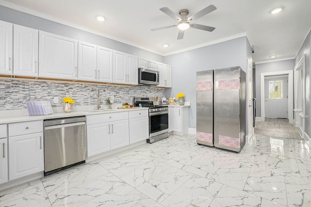 4411 Iroquois St, Detroit, MI 48214 - kitchen with crown molding, a sink, stainless steel appliances, light countertops, and recessed lighting