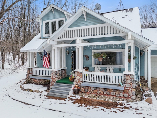 view of front of home featuring a porch and a garage
