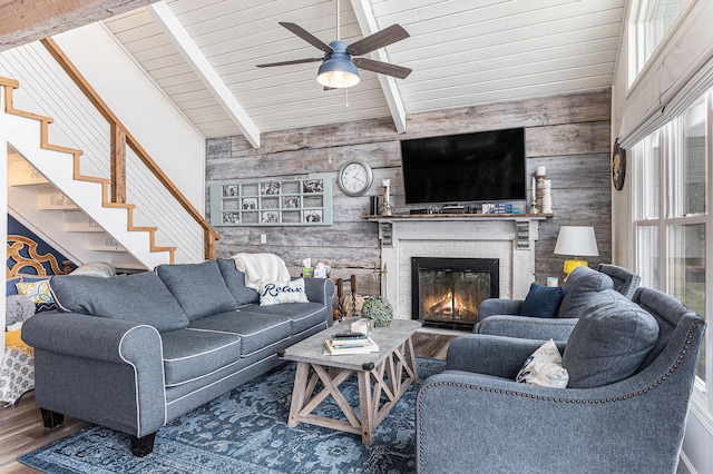 17570 Apache Trl, Howard City, MI 49329 - living area with a glass covered fireplace, wood finished floors, wood walls, and a ceiling fan