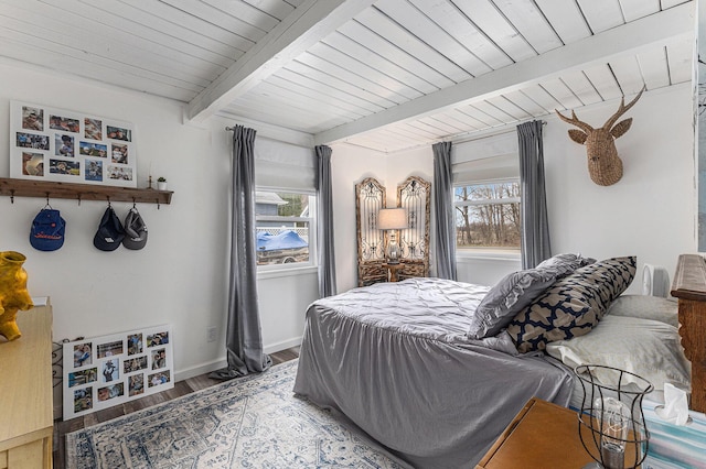 17570 Apache Trl, Howard City, MI 49329 - bedroom with baseboards, wood finished floors, beam ceiling, and multiple windows