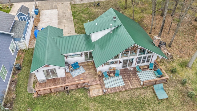 17570 Apache Trl, Howard City, MI 49329 - rear view of house with a chimney, metal roof, and a deck