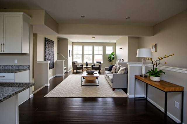 living area featuring dark wood finished floors and baseboards