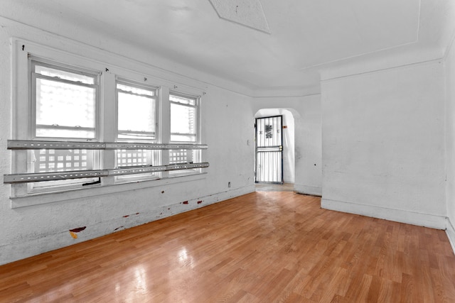 14919 Lesure St, Detroit, MI 48227 - empty room with arched walkways and wood finished floors