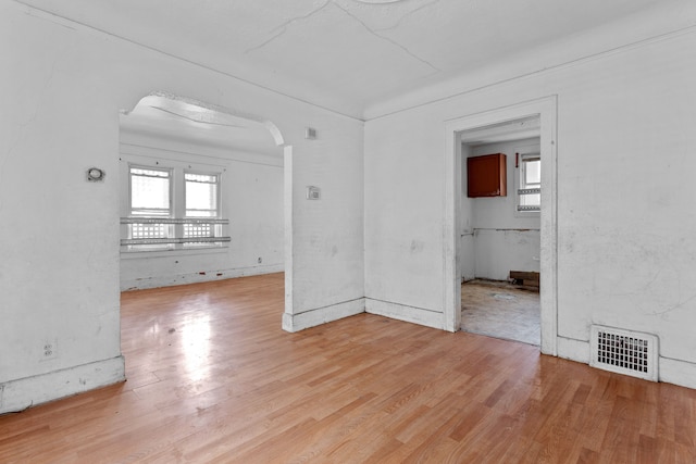 14919 Lesure St, Detroit, MI 48227 - spare room featuring arched walkways, healthy amount of natural light, and light wood finished floors