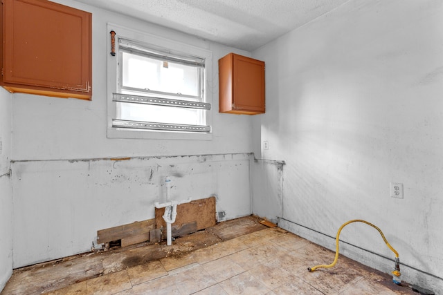 14919 Lesure St, Detroit, MI 48227 - kitchen with a textured ceiling and brown cabinets