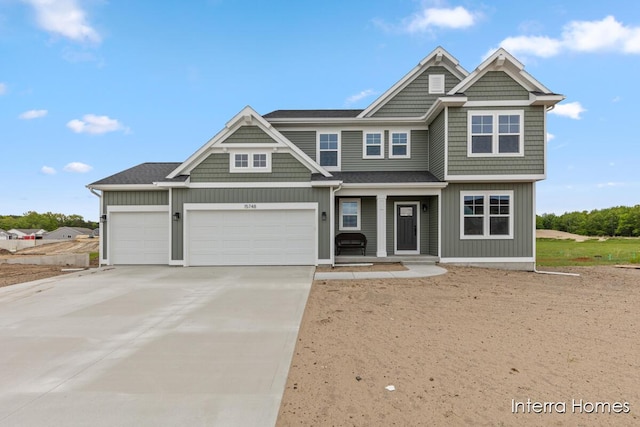 15748 Norwalk Rd, Grand Haven, MI 49417 - view of front of house featuring a porch, concrete driveway, and a garage