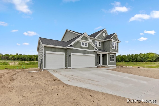 15748 Norwalk Rd, Grand Haven, MI 49417 - view of front of property with concrete driveway, board and batten siding, and a garage