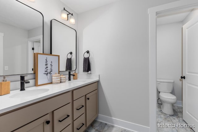 15748 Norwalk Rd, Grand Haven, MI 49417 - bathroom featuring marble look tile flooring, double vanity, baseboards, and toilet