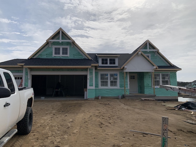 view of front of house featuring driveway and a shingled roof