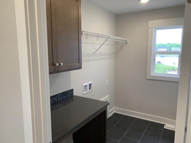 12580 Riverton Rd, Grand Haven, MI 49417 - washroom with cabinet space, hookup for a washing machine, and dark tile patterned flooring
