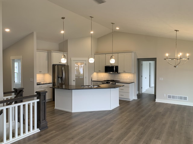 12580 Riverton Rd, Grand Haven, MI 49417 - kitchen with appliances with stainless steel finishes, dark countertops, backsplash, white cabinetry, and high vaulted ceiling