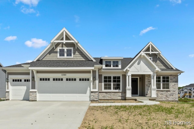 12580 Riverton Rd, Grand Haven, MI 49417 - craftsman-style house featuring stone siding, driveway, an attached garage, and a shingled roof