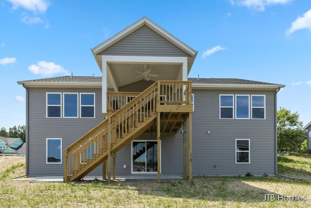 12580 Riverton Rd, Grand Haven, MI 49417 - rear view of property featuring stairway, ceiling fan, a wooden deck, and a lawn