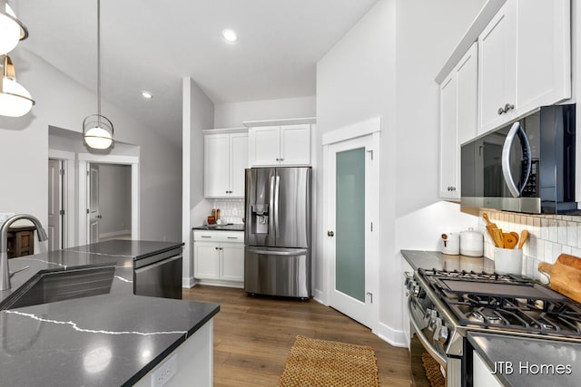 12580 Riverton Rd, Grand Haven, MI 49417 - kitchen featuring stainless steel appliances, tasteful backsplash, white cabinets, dark wood-style floors, and recessed lighting