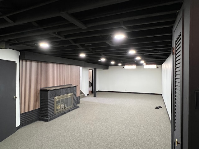 basement featuring washer / dryer, carpet flooring, and a brick fireplace
