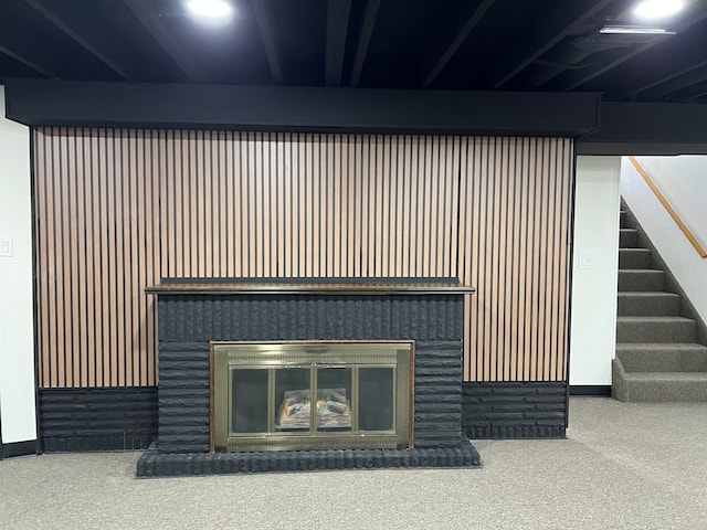 room details featuring baseboards, a glass covered fireplace, and carpet
