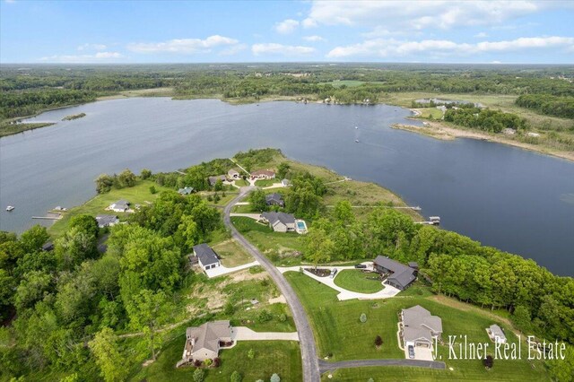 9465 Wabasis Pointe Dr NE, Greenville, MI 48838 - aerial view of property and surrounding area featuring a large body of water and a heavily wooded area