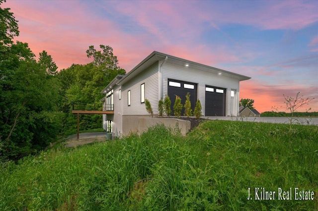 9465 Wabasis Pointe Dr NE, Greenville, MI 48838 - property exterior at dusk featuring a garage