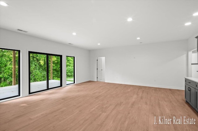 9465 Wabasis Pointe Dr NE, Greenville, MI 48838 - unfurnished living room featuring recessed lighting, light wood finished floors, and baseboards