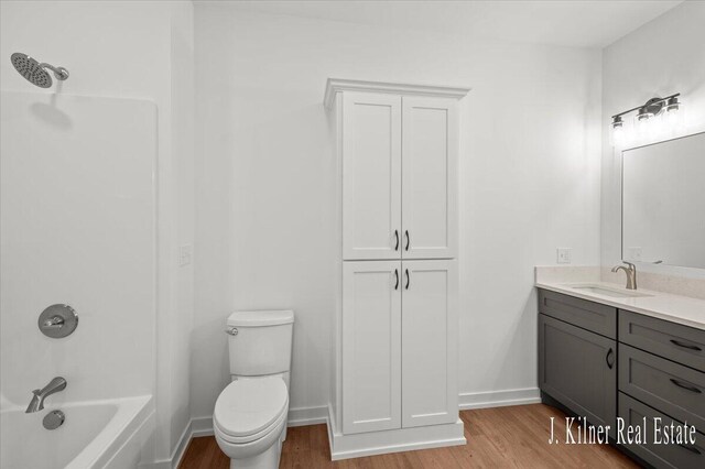 9465 Wabasis Pointe Dr NE, Greenville, MI 48838 - full bath with wood finished floors, vanity, toilet, and tub / shower combination