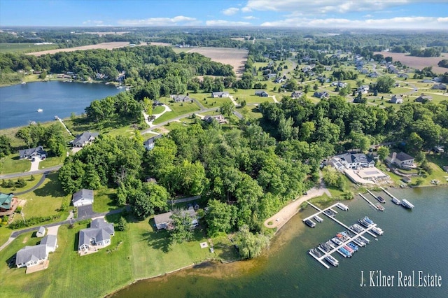 9465 Wabasis Pointe Dr NE, Greenville, MI 48838 - aerial view of property's location featuring a nearby body of water and a tree filled landscape