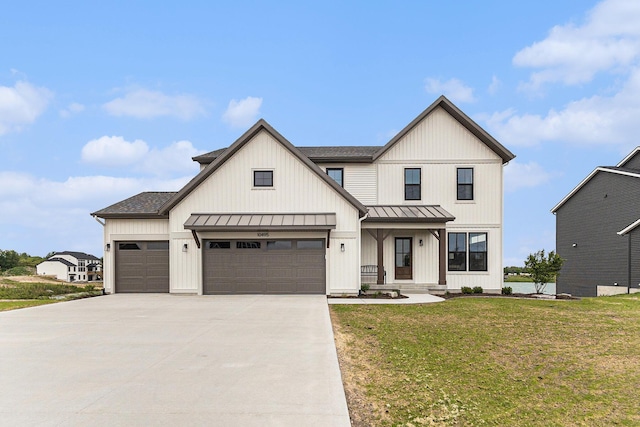 10495 Poppy Ln, Allendale, MI 49401 - modern farmhouse featuring a standing seam roof, a front lawn, concrete driveway, and a garage