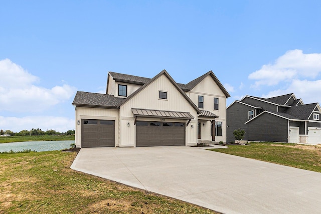 10495 Poppy Ln, Allendale, MI 49401 - modern inspired farmhouse featuring a standing seam roof, concrete driveway, a front lawn, a water view, and metal roof