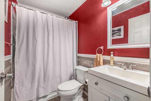 1315 Beaverbrook Dr, Holly, MI 48442 - bathroom featuring a wainscoted wall, toilet, vanity, tile walls, and a textured ceiling