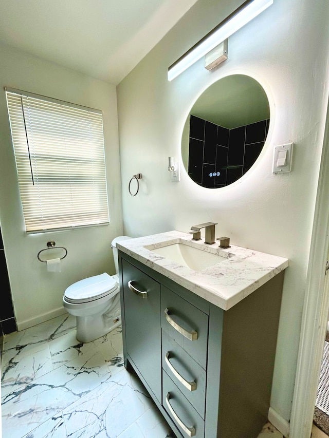 10342 Britain St, Detroit, MI 48224 - bathroom featuring vanity, toilet, marble finish floor, and baseboards