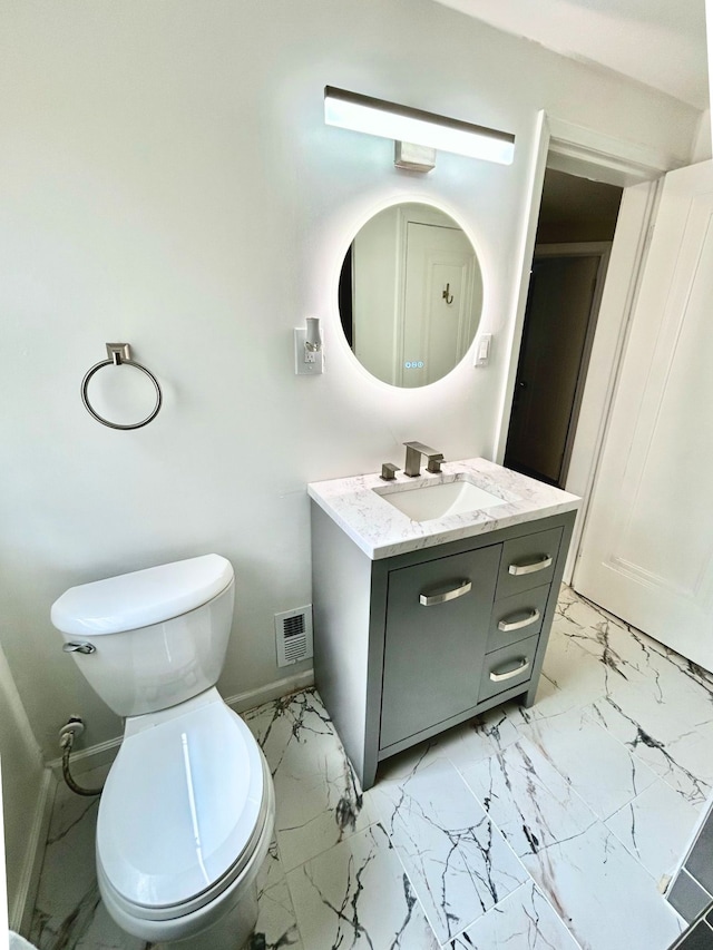 10342 Britain St, Detroit, MI 48224 - bathroom with marble finish floor, toilet, vanity, baseboards, and visible vents