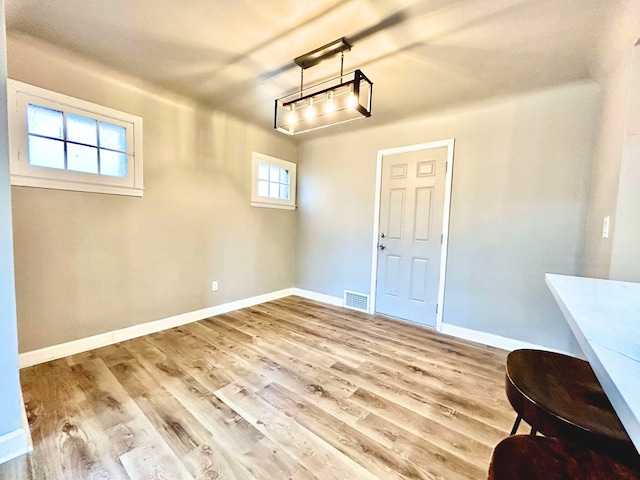 10342 Britain St, Detroit, MI 48224 - unfurnished dining area featuring wood finished floors, visible vents, and baseboards