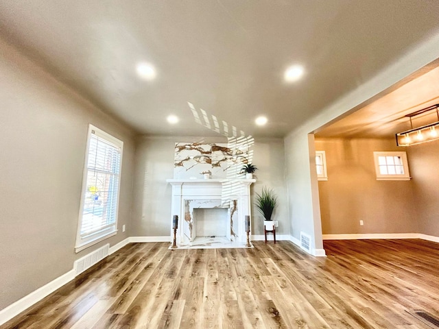 10342 Britain St, Detroit, MI 48224 - unfurnished living room with a premium fireplace, visible vents, and wood finished floors