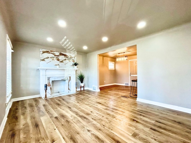 10342 Britain St, Detroit, MI 48224 - unfurnished living room featuring recessed lighting, visible vents, wood finished floors, and a fireplace
