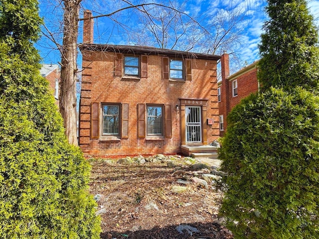 10342 Britain St, Detroit, MI 48224 - view of front of house featuring a chimney and brick siding