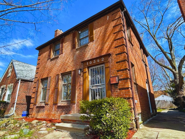 10342 Britain St, Detroit, MI 48224 - view of front of house with a chimney and brick siding