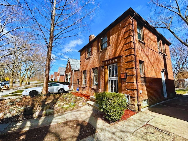10342 Britain St, Detroit, MI 48224 - view of front of home featuring a chimney and brick siding