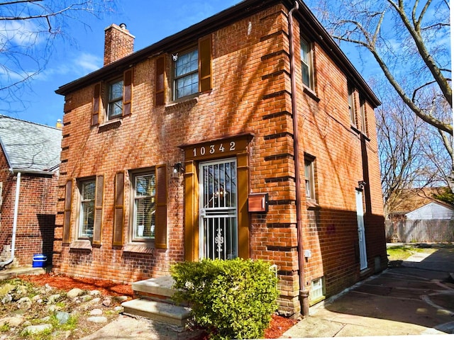 10342 Britain St, Detroit, MI 48224 - view of front of home featuring a chimney and brick siding