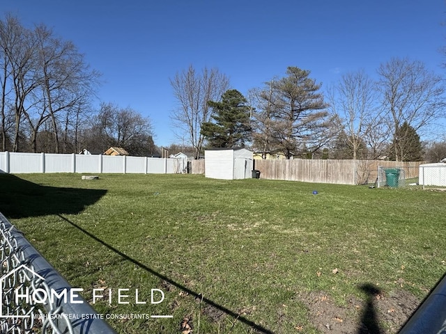 view of yard featuring a storage shed, a fenced backyard, and an outdoor structure