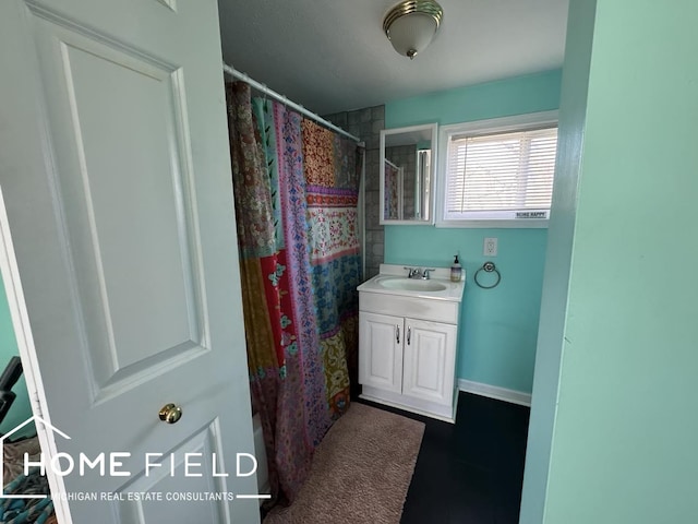 bathroom featuring vanity and curtained shower