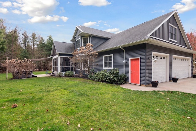 17867 K-Line Way, Marshall, MI 49068 - view of front of property featuring driveway, a garage, a shingled roof, a sunroom, and a front yard